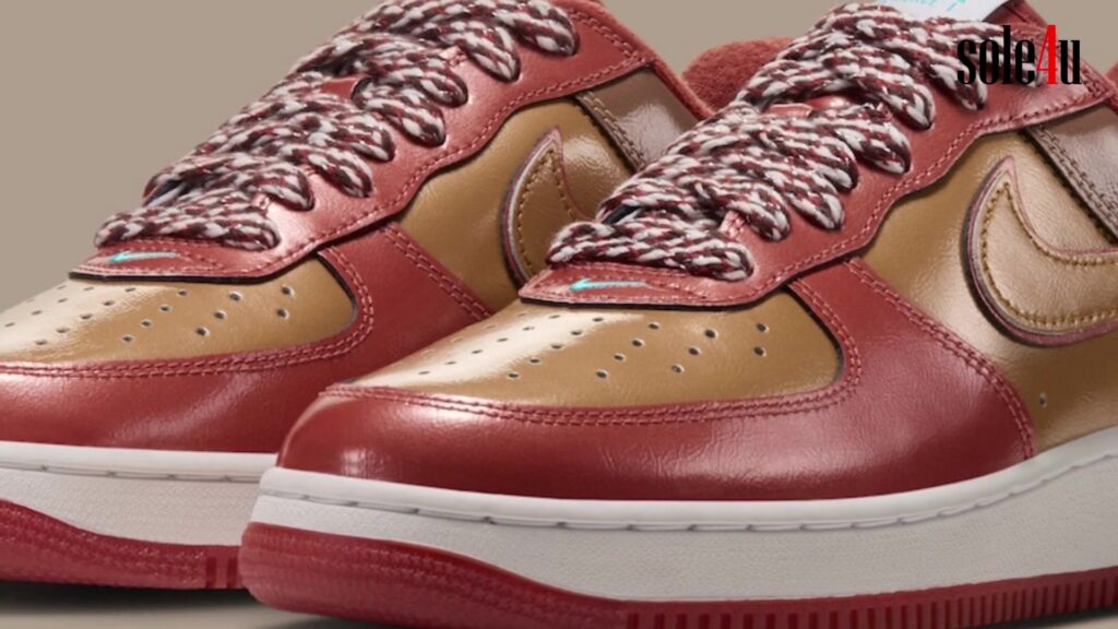 De Air Force 1 Burnt Sunrise van Nigo en j-hope in oranje en goud lakleer met gedraaide veters